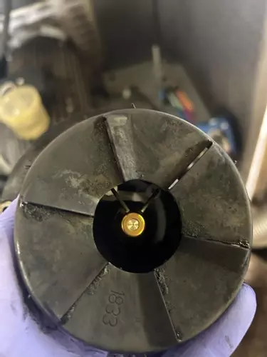 Close-up of cleaned burner nozzle and electrodes after servicing on a Nilfisk SH Truck Booster, showing improved condition for efficient combustion.